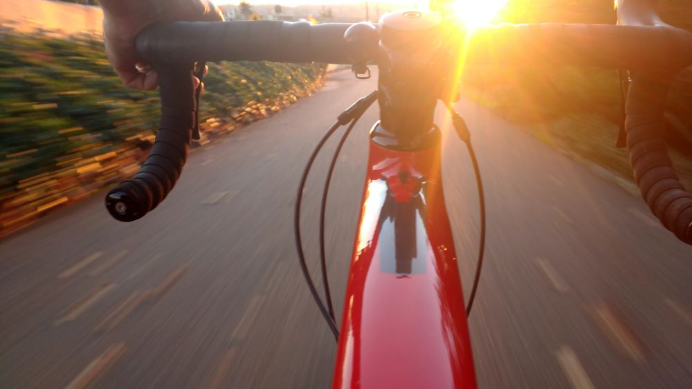 A bike being ridden at sunset