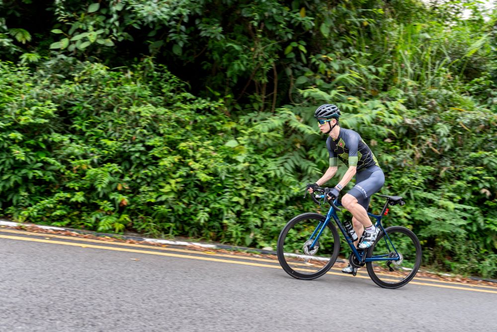 A cyclist cycling up a hill