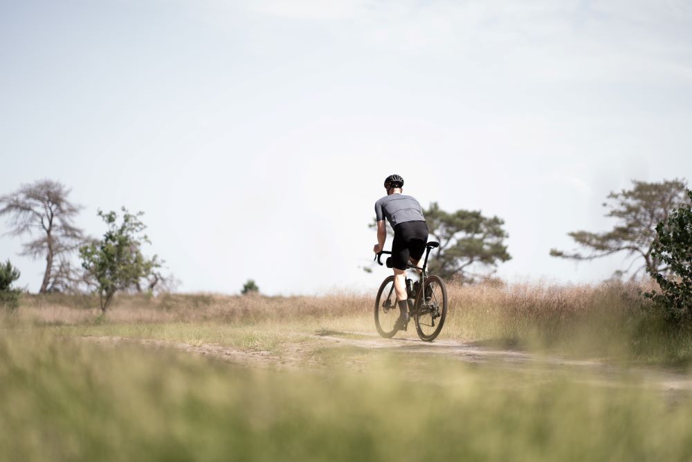 a person rides a gravel bike in the countryside